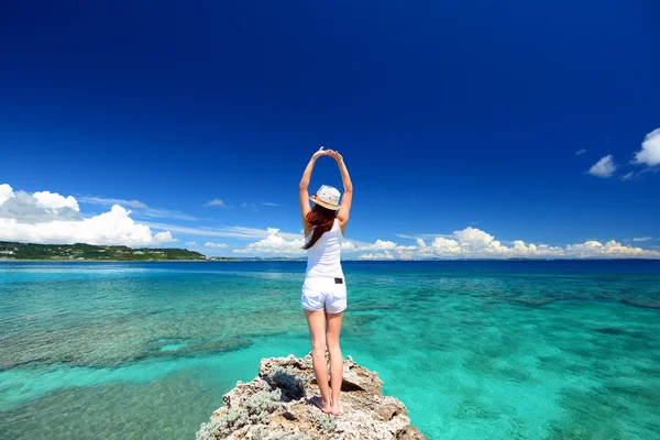Young woman doing stretching on beach — Stock Photo, Image