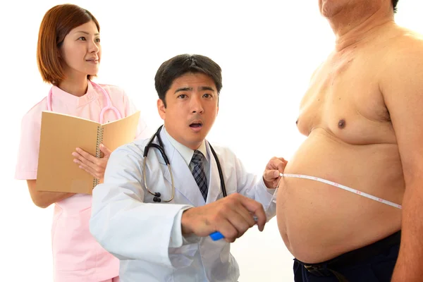 Ernsthafter Arzt untersucht Fettleibigkeit eines Patienten — Stockfoto