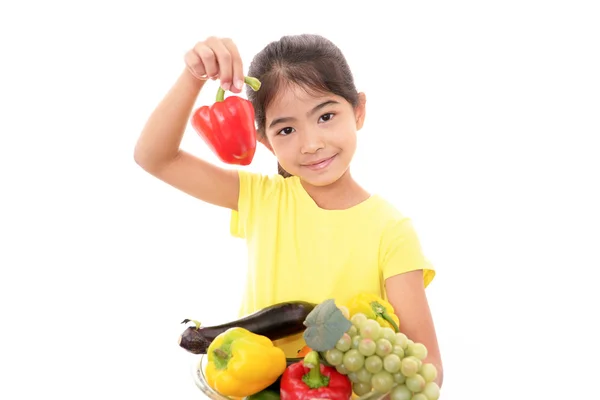 Smiling girl holding vegetables — Stock Photo, Image