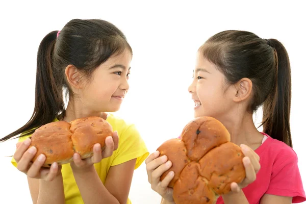 Smiling Asian girls holding a bread — Stok fotoğraf