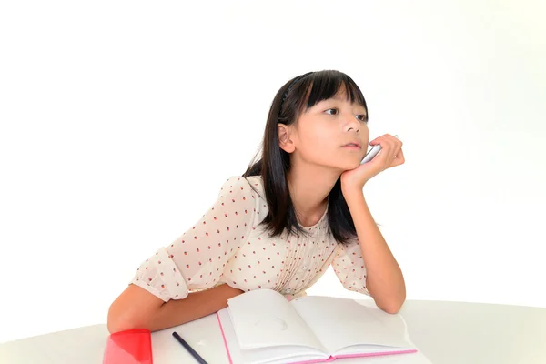 Menina entediada sentado em sua mesa — Fotografia de Stock