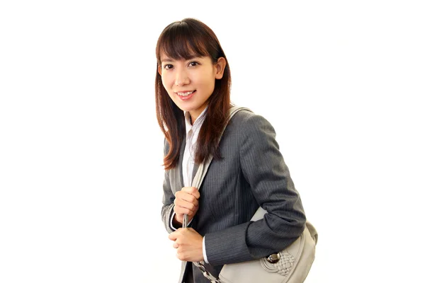 Mujer joven sonriente sosteniendo un bolso de hombro — Foto de Stock