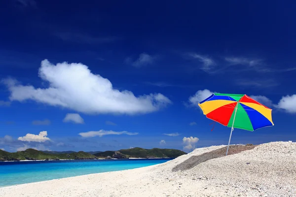 A praia e o guarda-chuva de praia de meados do verão . — Fotografia de Stock