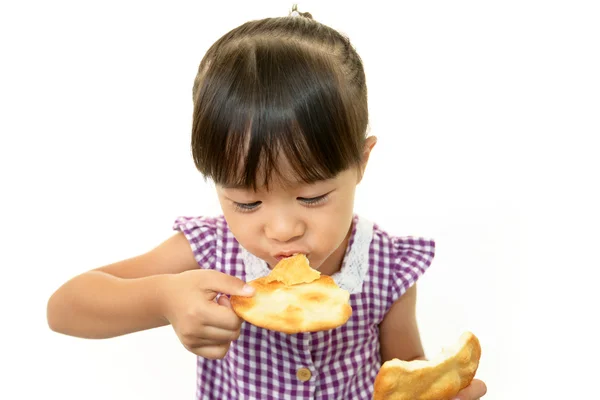 Happy kid eating snack — Stock Photo, Image