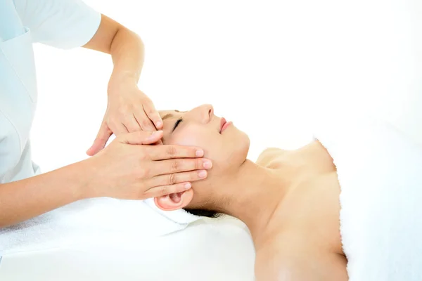 Beautiful young woman receiving facial massage — Stock Photo, Image