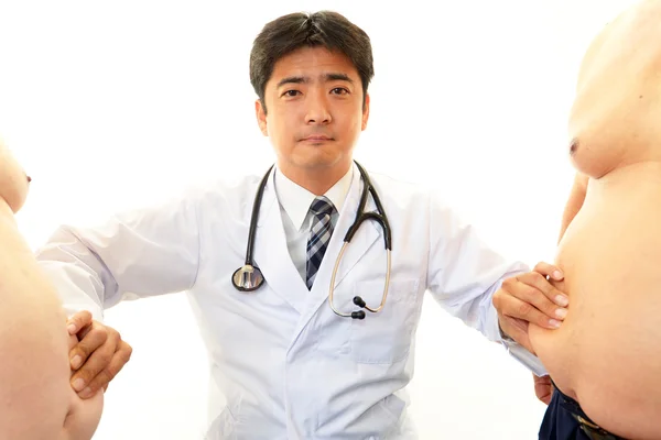 Serious doctor examining patients obesity — Stock Photo, Image
