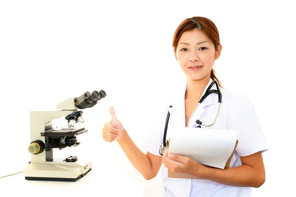 Doctor with a microscopic examination — Stock Photo, Image