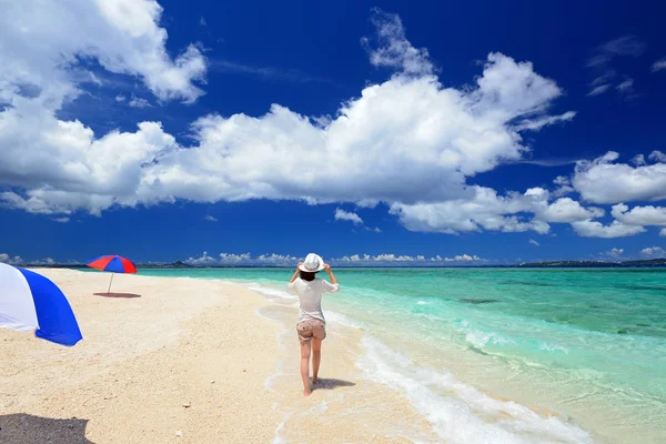 Jeune femme sur la plage profiter de la lumière du soleil — Photo