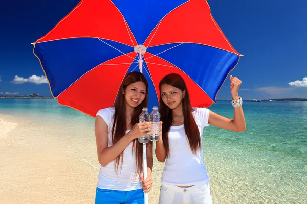 Młode kobiety na plaży cieszyć się światło słoneczne — Zdjęcie stockowe
