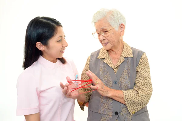 Senior woman with her home caregiver — Stock Photo, Image