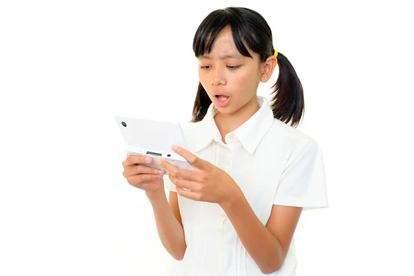 Girl wit Handheld video game — Stock Photo, Image