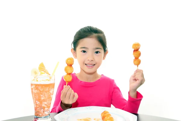 Happy child eating sweets — Stock Photo, Image