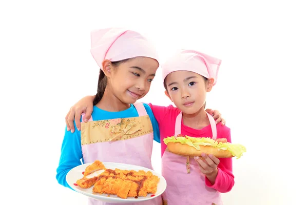 Smiling girls carrying meal — Stock Photo, Image