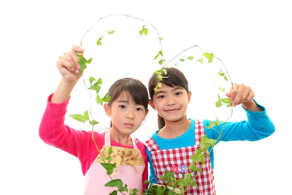 Lächelnde Mädchen mit Pflanze — Stockfoto