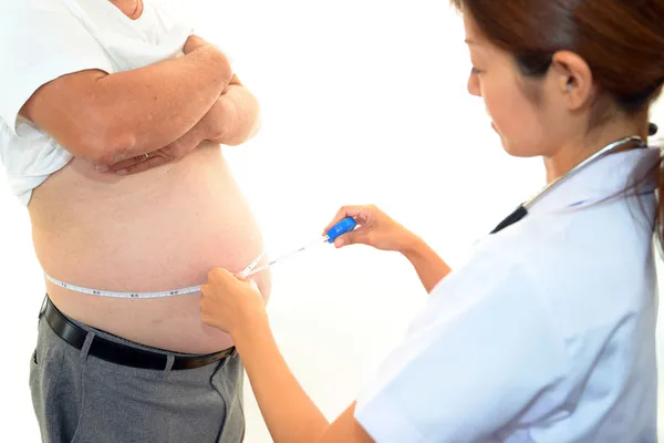Serious doctor examining a patient obesity — Stock Photo, Image