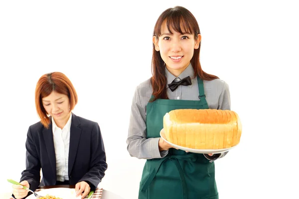 Waitress delivering bread to table — Stock Photo, Image