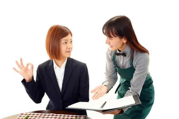 Waitress shows the menu to customer — Stock Photo, Image