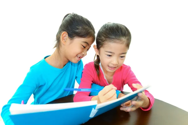 Happy girls studying at the desk — Stock Photo, Image