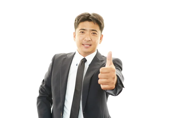 Glad affärsman som visar tummen upp tecken — Stockfoto