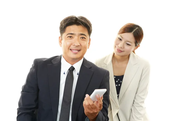 Smiling businessman and businesswoman — Stock Photo, Image