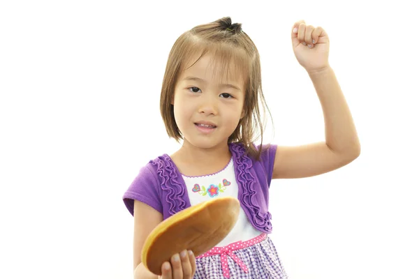 Happy kid holding a sweet — Stock Photo, Image
