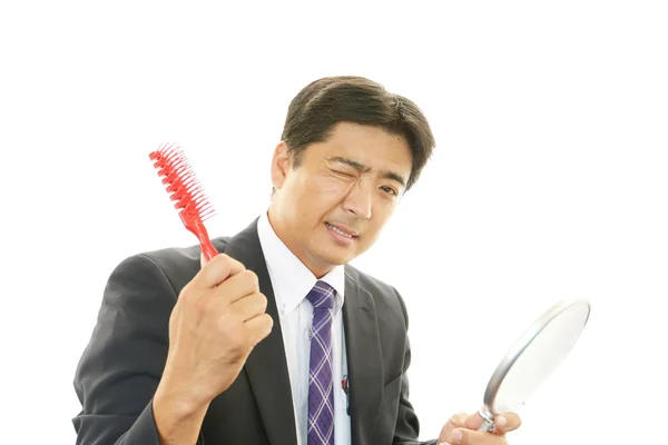 Asian businessman in a uneasy look — Stock Photo, Image