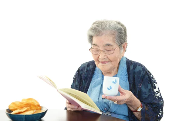 늙은 여자는 그녀의 책을 읽고 — 스톡 사진