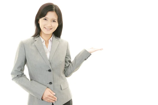 Business woman showing something on the palm of her hand — Stock Photo, Image