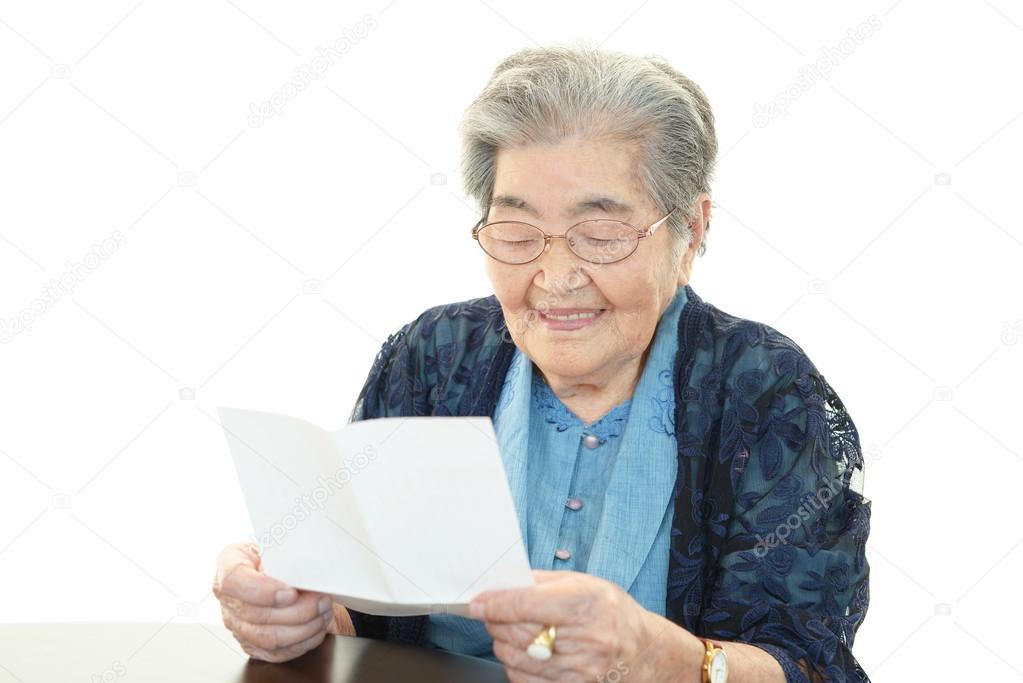 Old woman reading a letter
