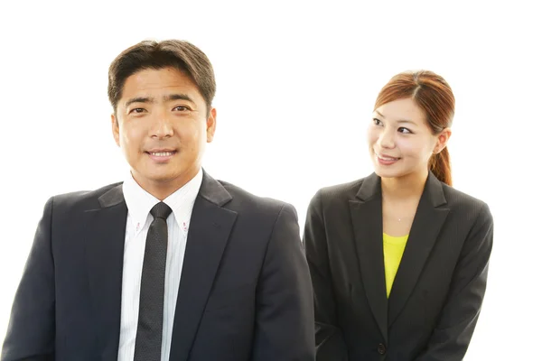 Smiling businessman and businesswoman — Stock Photo, Image