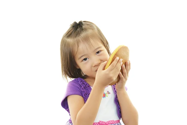 Happy kid holding a sweet — Stock Photo, Image