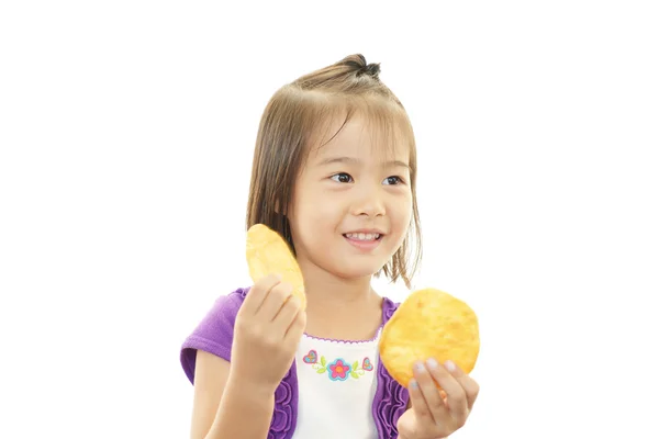 Happy kid holding snacks — Stock Photo, Image