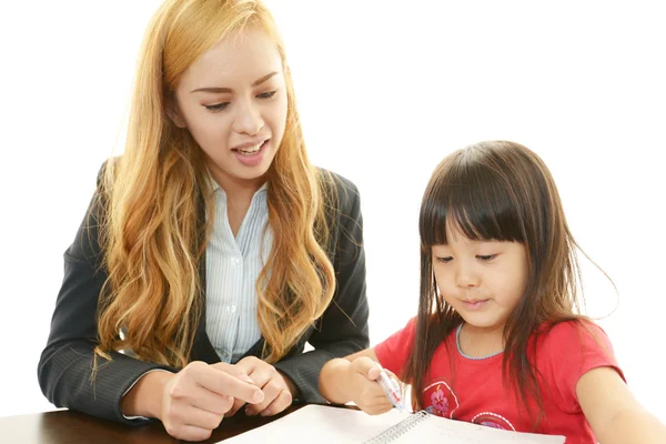 English teacher with girl studying. — Stock Photo, Image