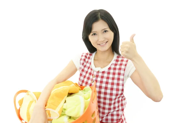 The woman is holding a Laundry basket — Stock Photo, Image