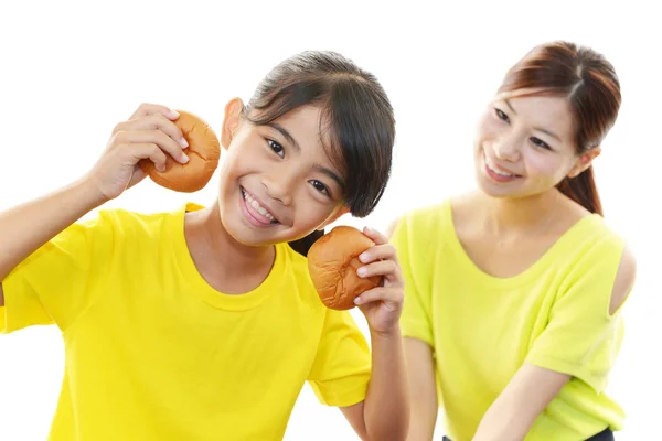 Girl holding breads — Stock Photo, Image