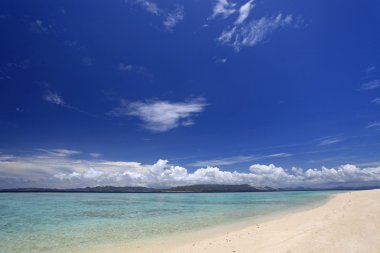 Yaz gökyüzü ve Okinawa 'nın güzel plajı