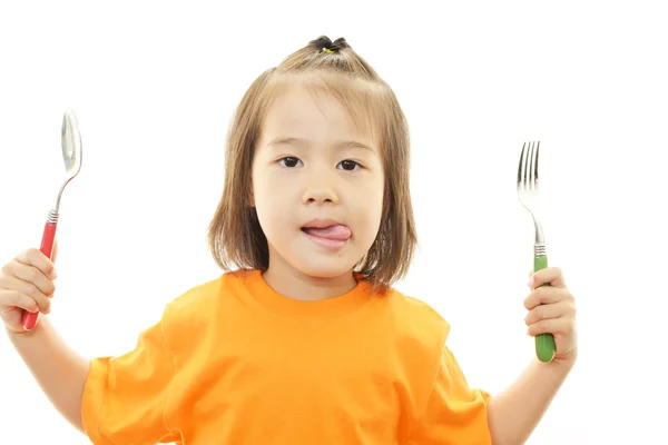 Happy kid holding fork and spoon — Stock Photo, Image