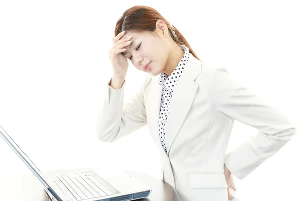 Tired young Asian business woman — Stock Photo, Image