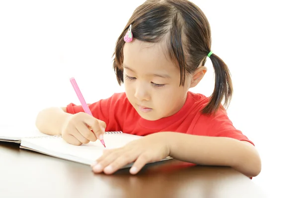 Little girl studying at the desk Royalty Free Stock Images