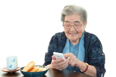 Old woman holding mobile phone clipart