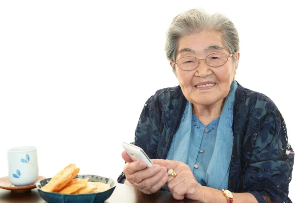 Mobile phone and old woman — Stock Photo, Image