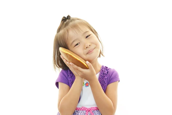 Happy kid holding a sweet — Stock Photo, Image