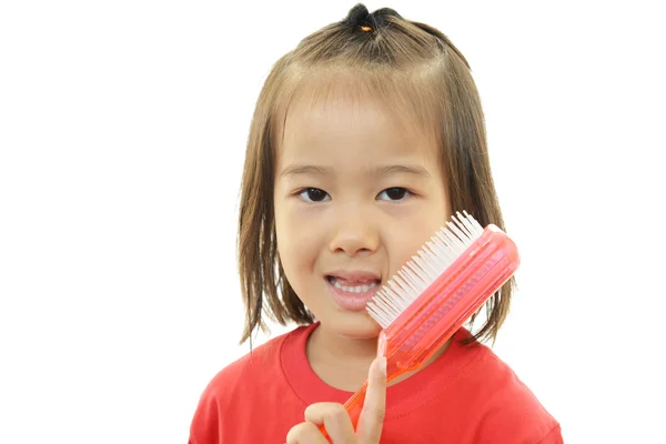 Little girl taking care of her hair — Stock Photo, Image