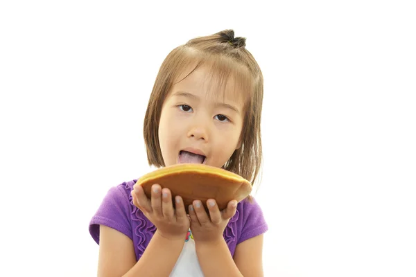 Happy kid holding a sweet — Stock Photo, Image