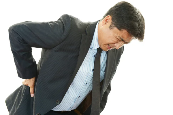 Empresário com dor nas costas — Fotografia de Stock