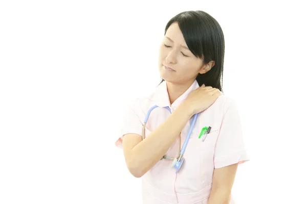 Nurse with shoulder pain. — Stock Photo, Image