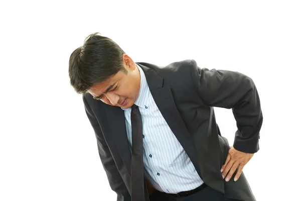 Businessman having back pain — Stock Photo, Image