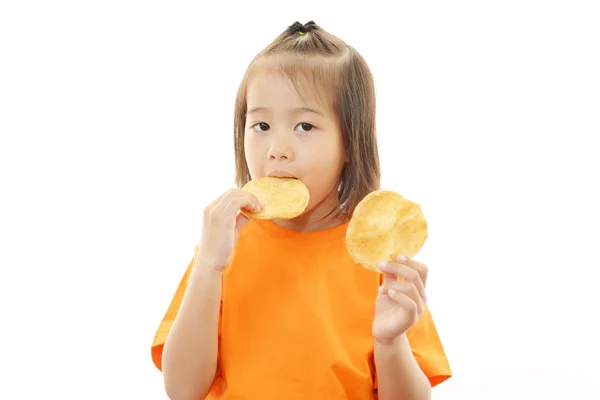 Happy kid eating snacks — Stock Photo, Image