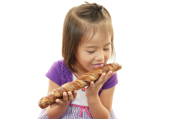 Little girl eating bread — Stock Photo, Image