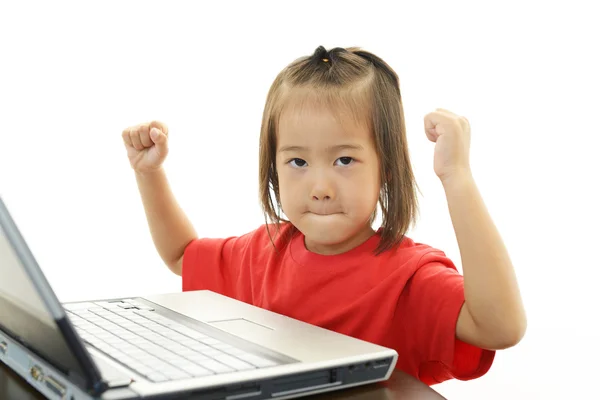 Cute little girl using a laptop — Stock Photo, Image